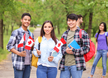Untitled design – 2026-08-07T192436.284 Students holding Canadian flags outdoors, representing Study Visa services
